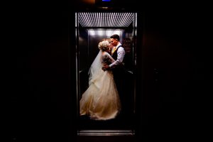 Bride and Groom in lift at The West Mill Derby
