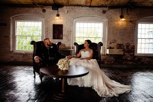 Bride and Groom sitting in chairs at The west Mill Derby
