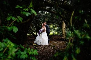 Bride and Groom in trees at Rothley Hall Leicester