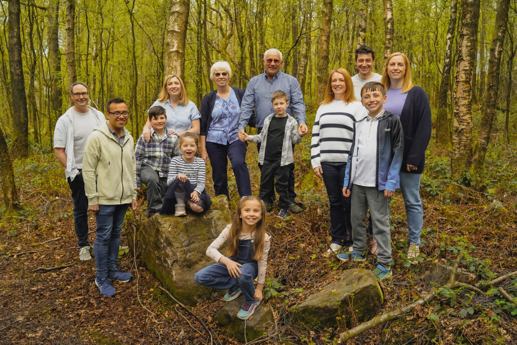 three generation of family together ini a woodland area